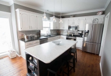 kitchen remodel-marble island countertop-white cabinets-pendant lights