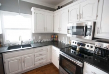 kitchen remodel-marble island countertop-white cabinets-pendant lights