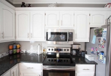 kitchen remodel-marble island countertop-white cabinets-pendant lights