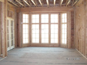Rebuilt wall framing and new window installation during a residential structural remodeling project.