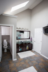 Custom bathroom built in converted space above a garage featuring a new vanity, private toilet room, and modern finishes as part of a Kansas City home remodeling project.