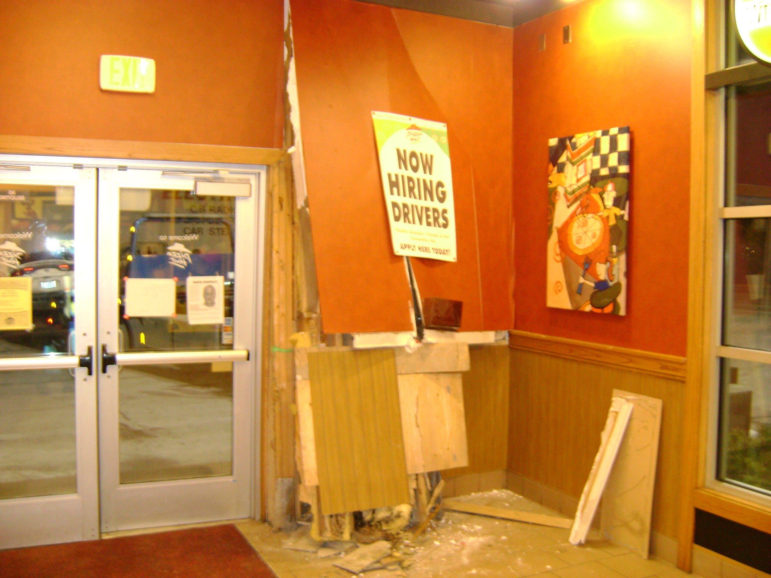Interior of a commercial restaurant showing structural damage after a vehicle crashed through the exterior wall before restoration began.